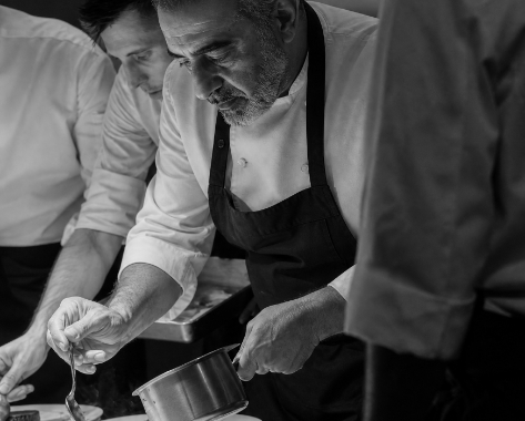 Chefs preparing dishes in the kitchen